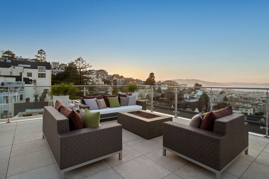 Broadway Rooftop Seating With Wicker Furniture, Fireplace And View Of The Bay