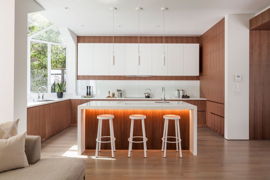 Broadway Modern Family Kitchen With Natural Lighting, Island Bar, Stools And Hanging Light Fixtures