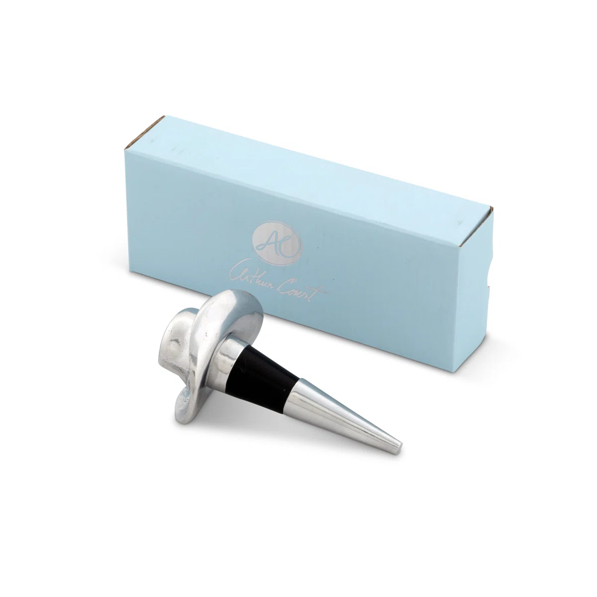 A silver wine bottle stopper with a black ring lies in front of a light blue rectangular box displaying a circular logo and the words “Arthur Court.”.