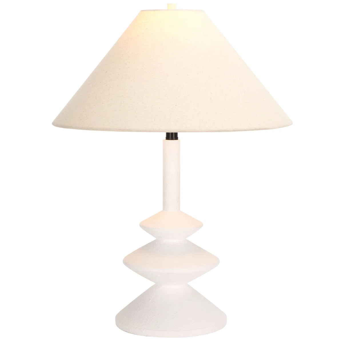 A modern white table lamp with a geometric, stacked base and a wide, cream-colored fabric lampshade. The lamp is photographed against a plain white background.