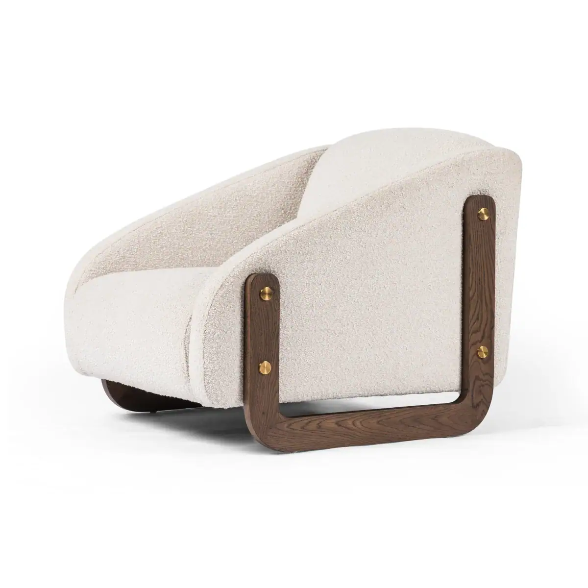 A modern armchair with a curved, plush off-white upholstered seat and backrest, supported by a dark wooden frame with brass accents, shown on a white background.