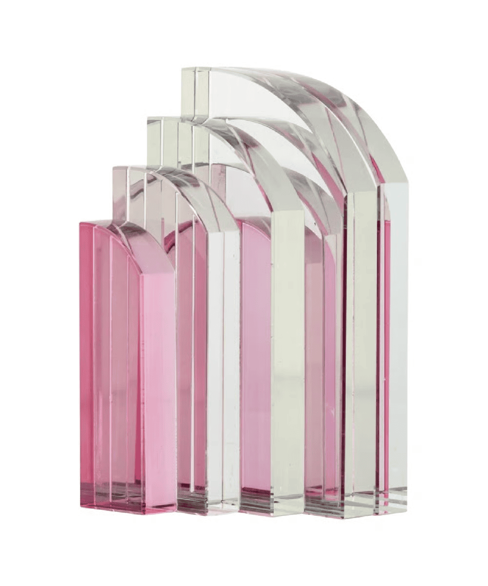 Five glass bookends in varying heights, with curved tops and gradient colors from clear to shades of pink, are arranged side by side in ascending order.