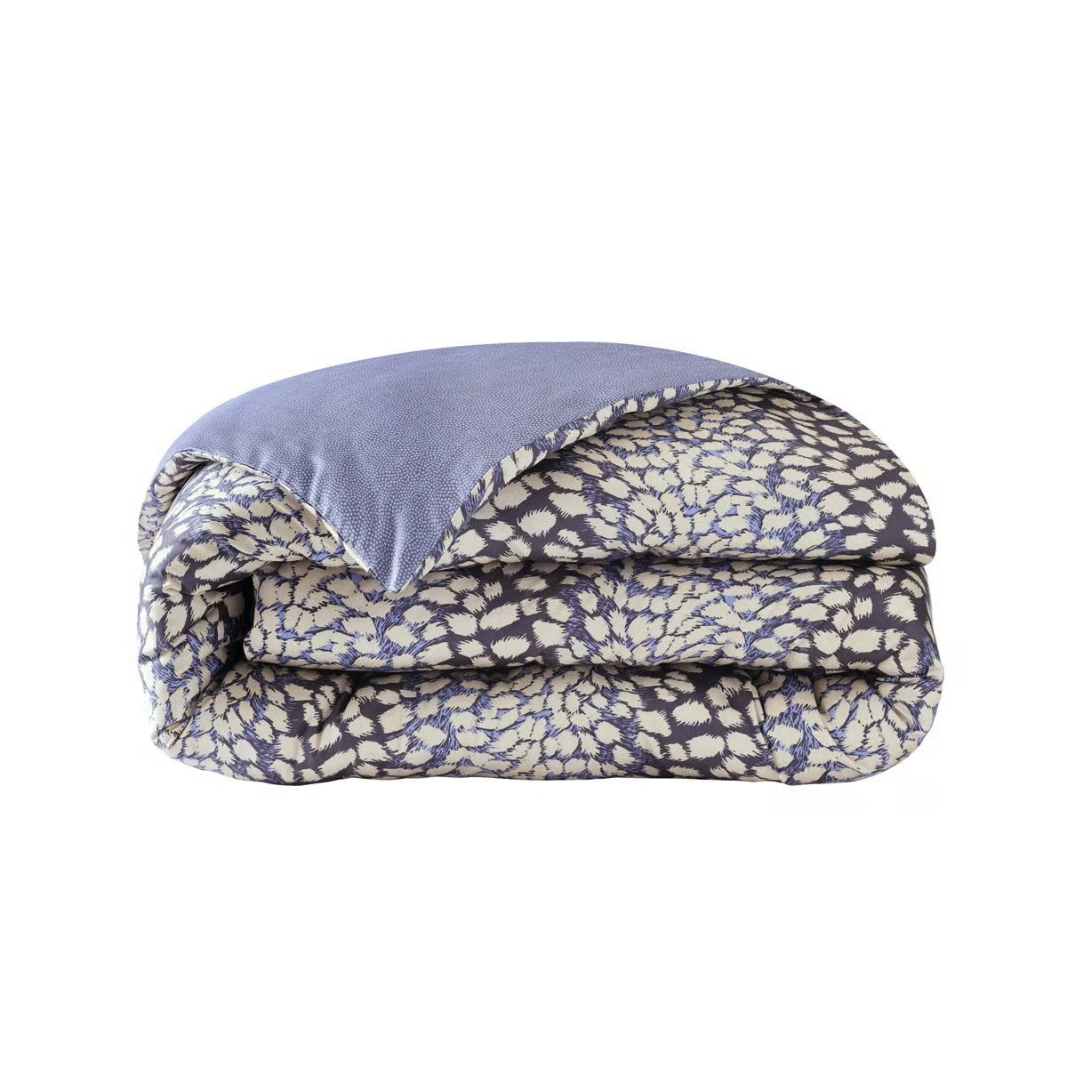 A folded comforter with a blue underside and a patterned top featuring cream and blue abstract designs on a dark background.