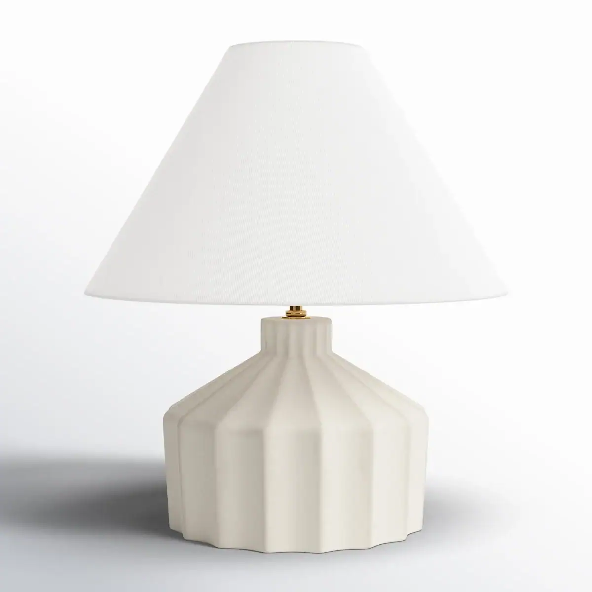A table lamp with a white, pleated ceramic base and a wide, white fabric lampshade, set against a plain background.